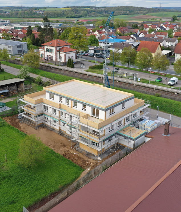 Aerial view of a multistory modular building under construction with scaffolding